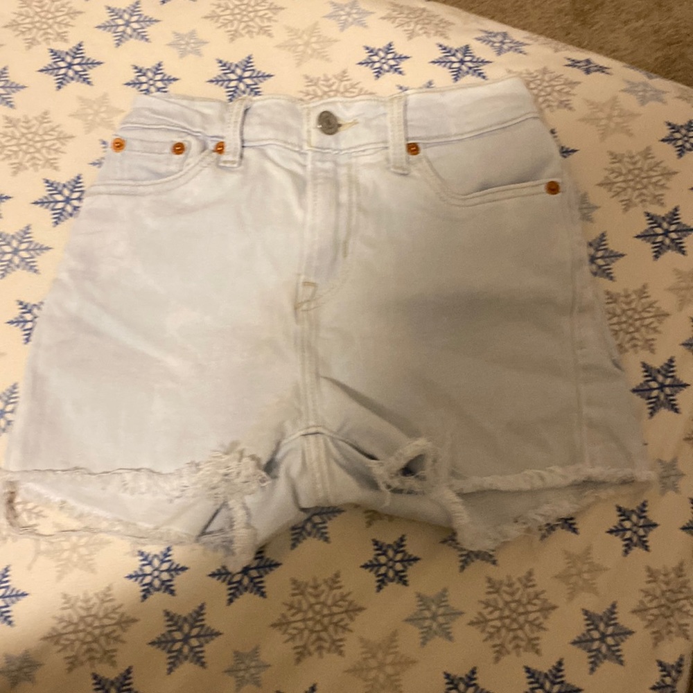 used 4 four pockets levisripped bottoms light blue small pink stain at the back